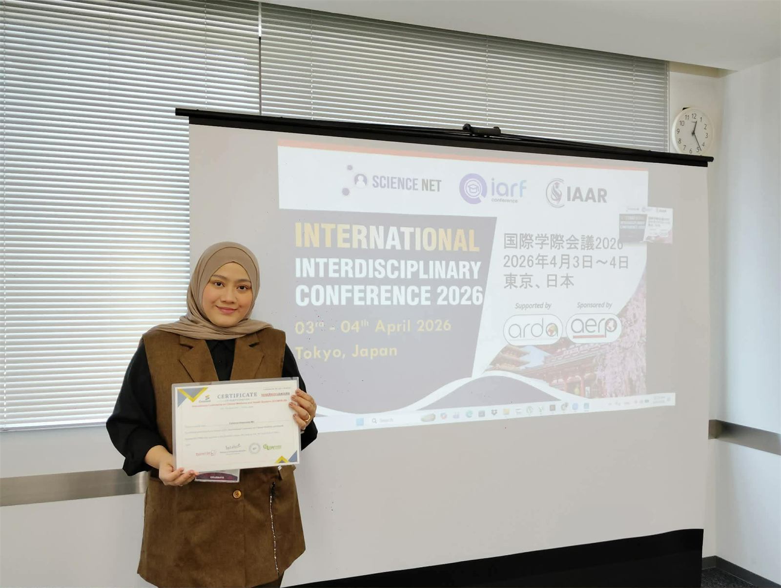 Researcher with a certificate at a JSIC conference